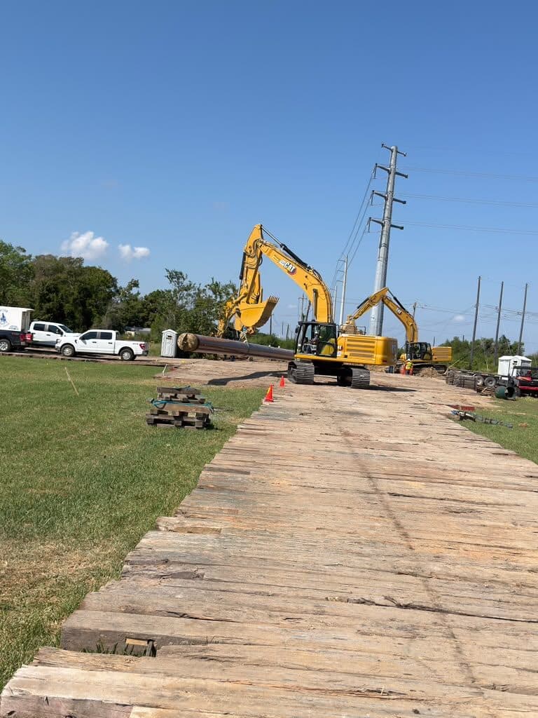 Timber mat access road built out to an excavator